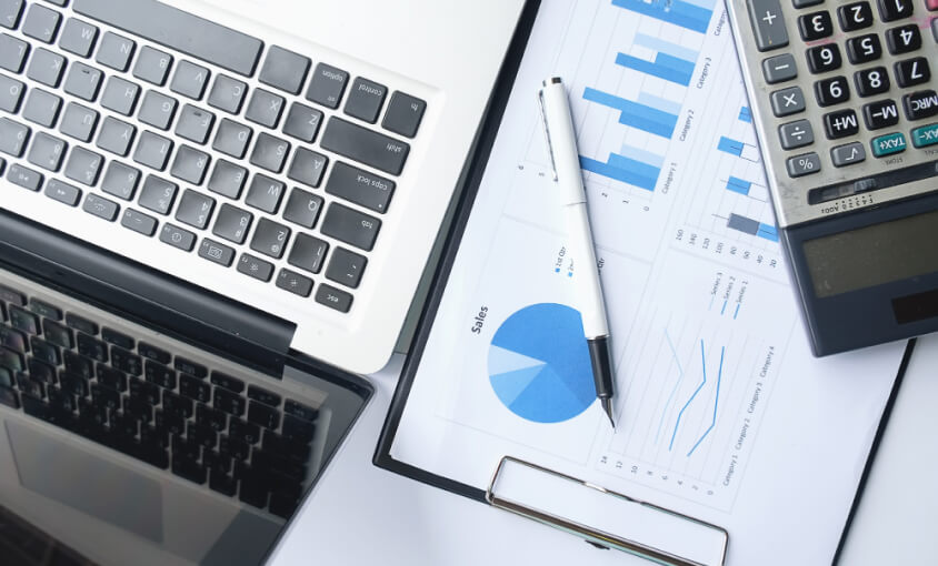 business concept with copy space office desk table with pen focus analysis chart computer notebook cup coffee desk vintage tone retro filter selective focus